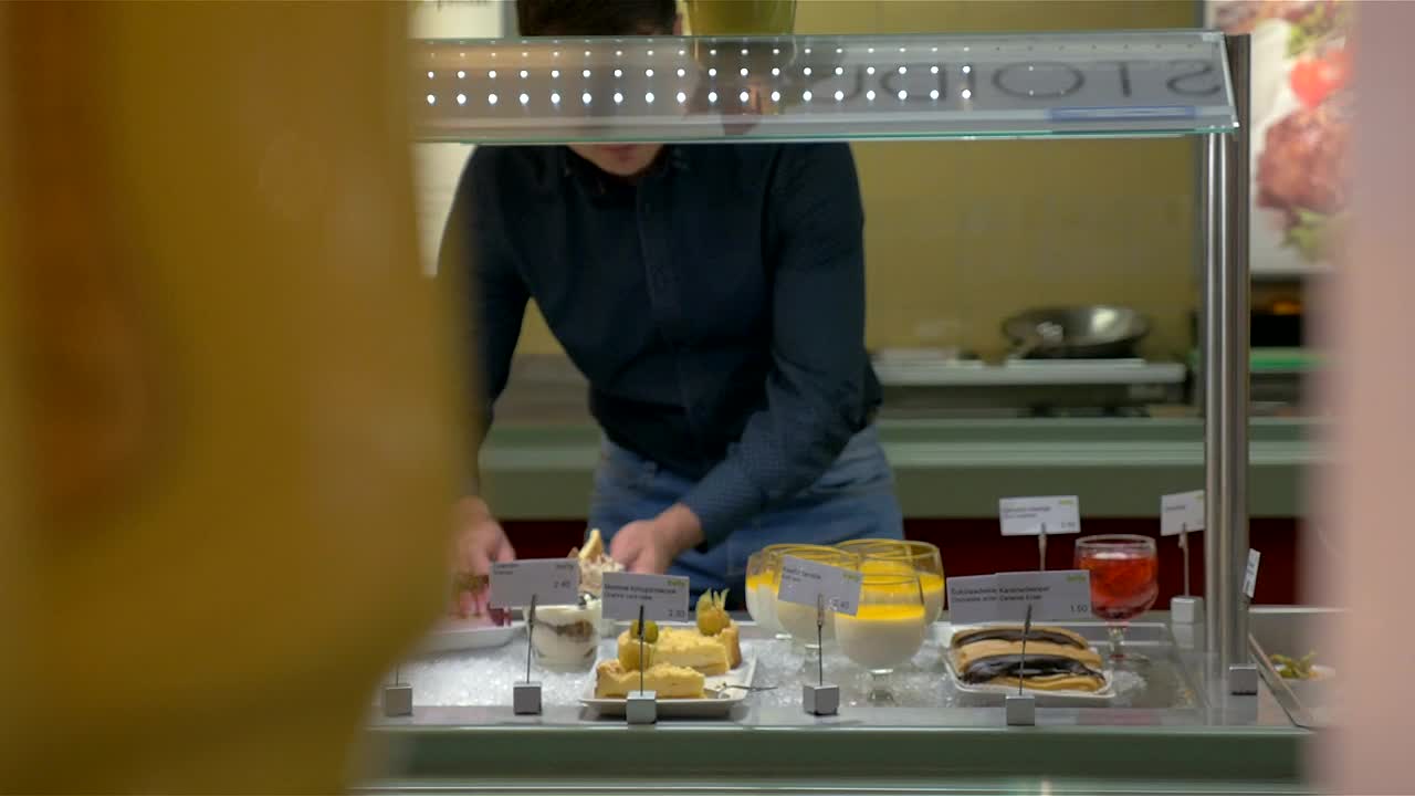 Stock Video Man Choosing Items From A Buffet Animated Wallpaper