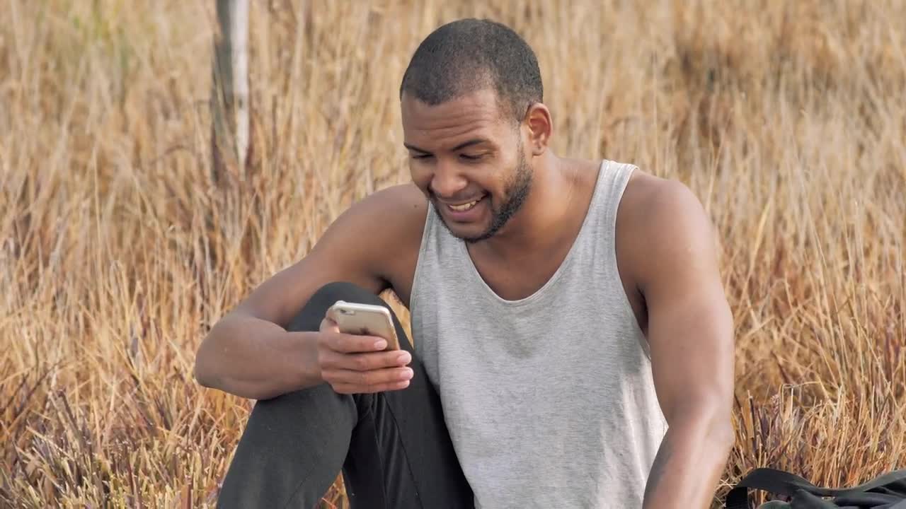 Stock Video Man Checks His Smartphone After Training Animated Wallpaper