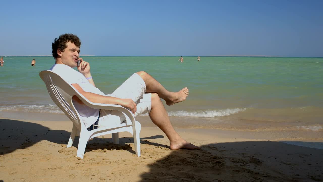 Stock Video Man Calling Home While On Vacation Animated Wallpaper