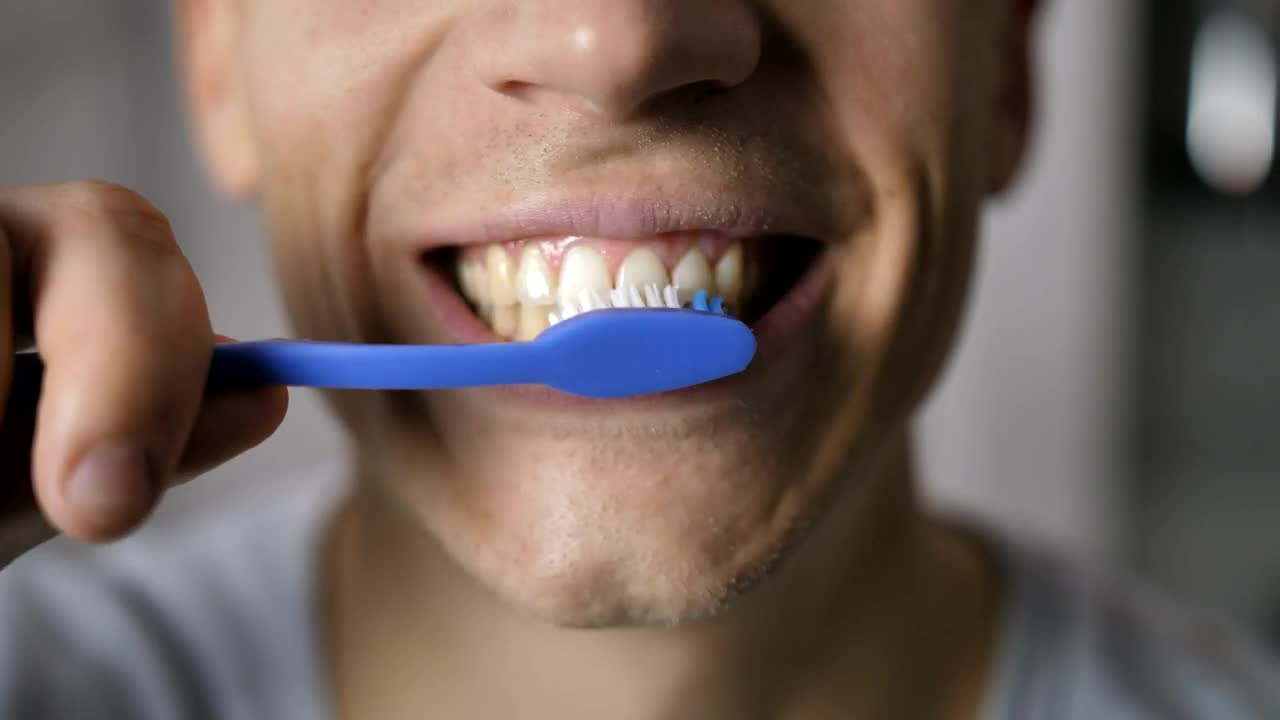 Stock Video Man Brushing His Teeth In A Very Close Shot Animated Wallpaper