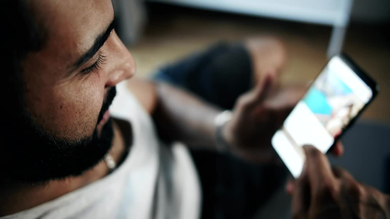 Stock Video Man Browsing Social Media On Smartphone Top View Animated Wallpaper