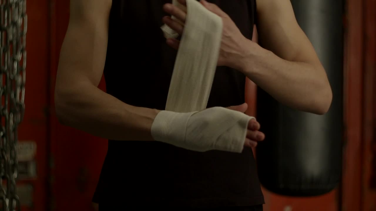 Stock Video Man Bandaging His Hand Before Boxing Animated Wallpaper