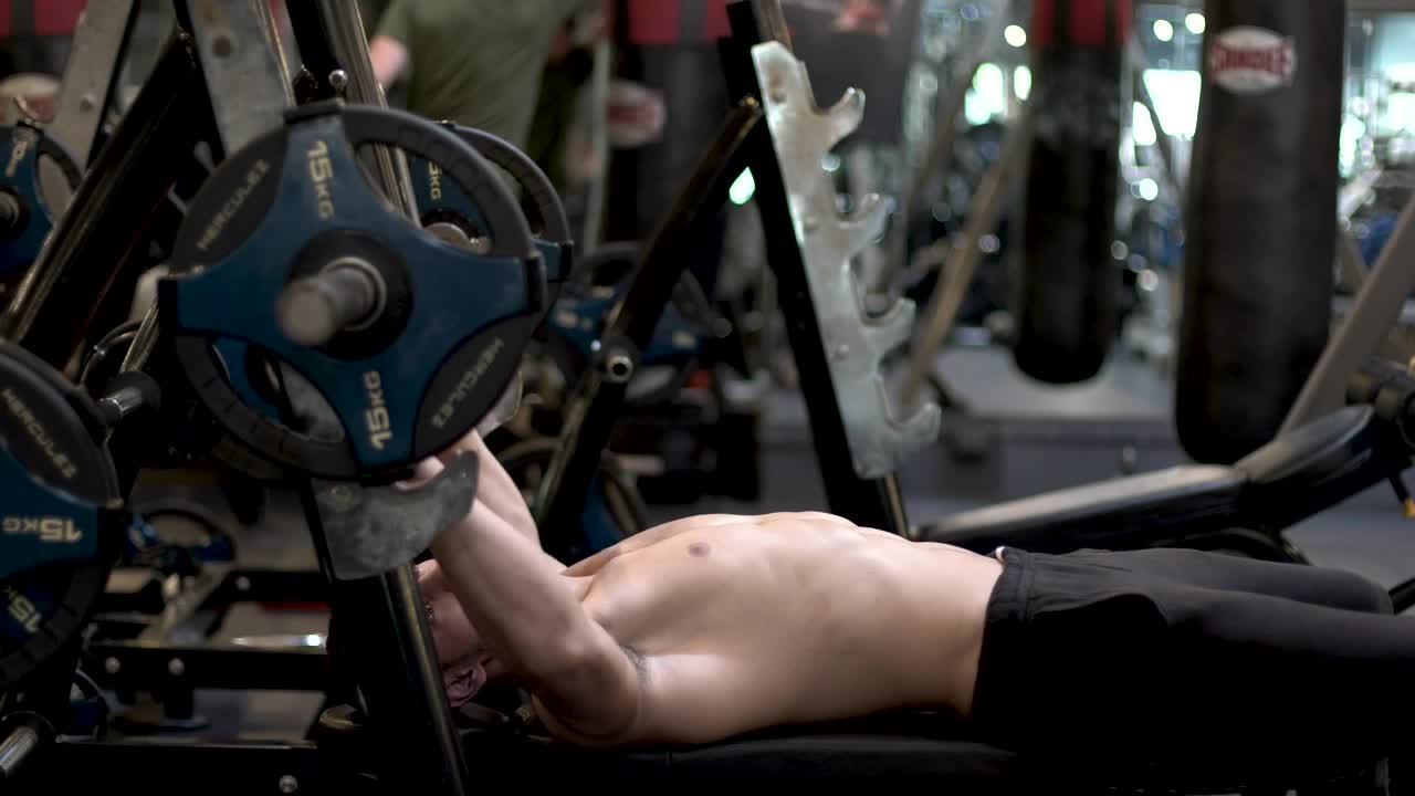 Stock Video Man At The Gym Exercising With A Dumbbell Animated Wallpaper