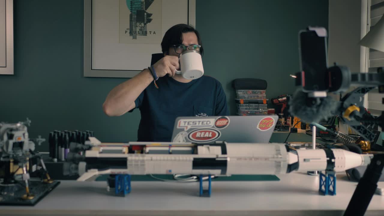 Stock Video Man At His Laptop In His Study With Many Objects Animated Wallpaper