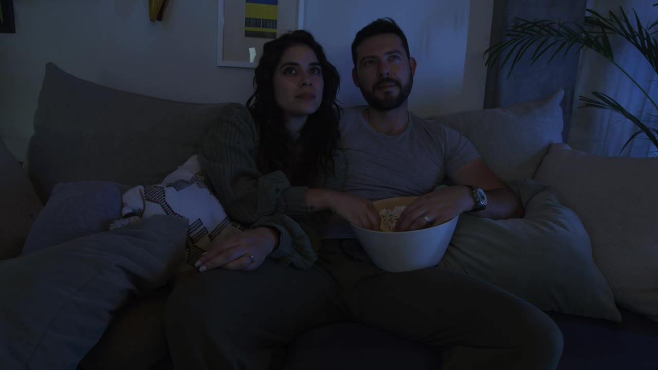 Stock Video Man And Woman Watching A Movie Together Animated Wallpaper