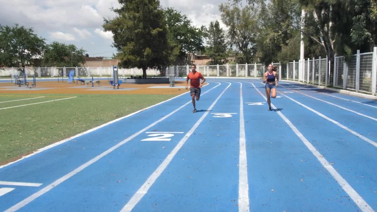 Stock Video Man And Woman Training On A Running Track Animated Wallpaper