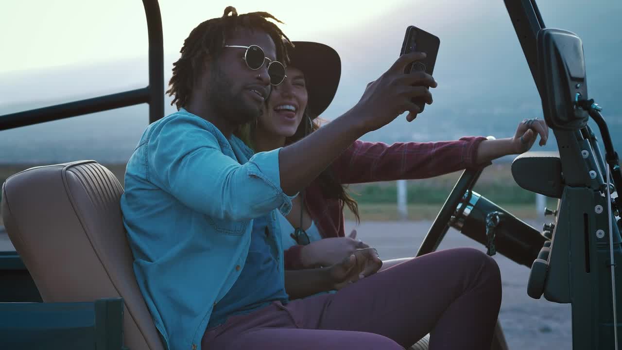 Stock Video Man And Woman Taking Selfies During A Road Trip Animated Wallpaper