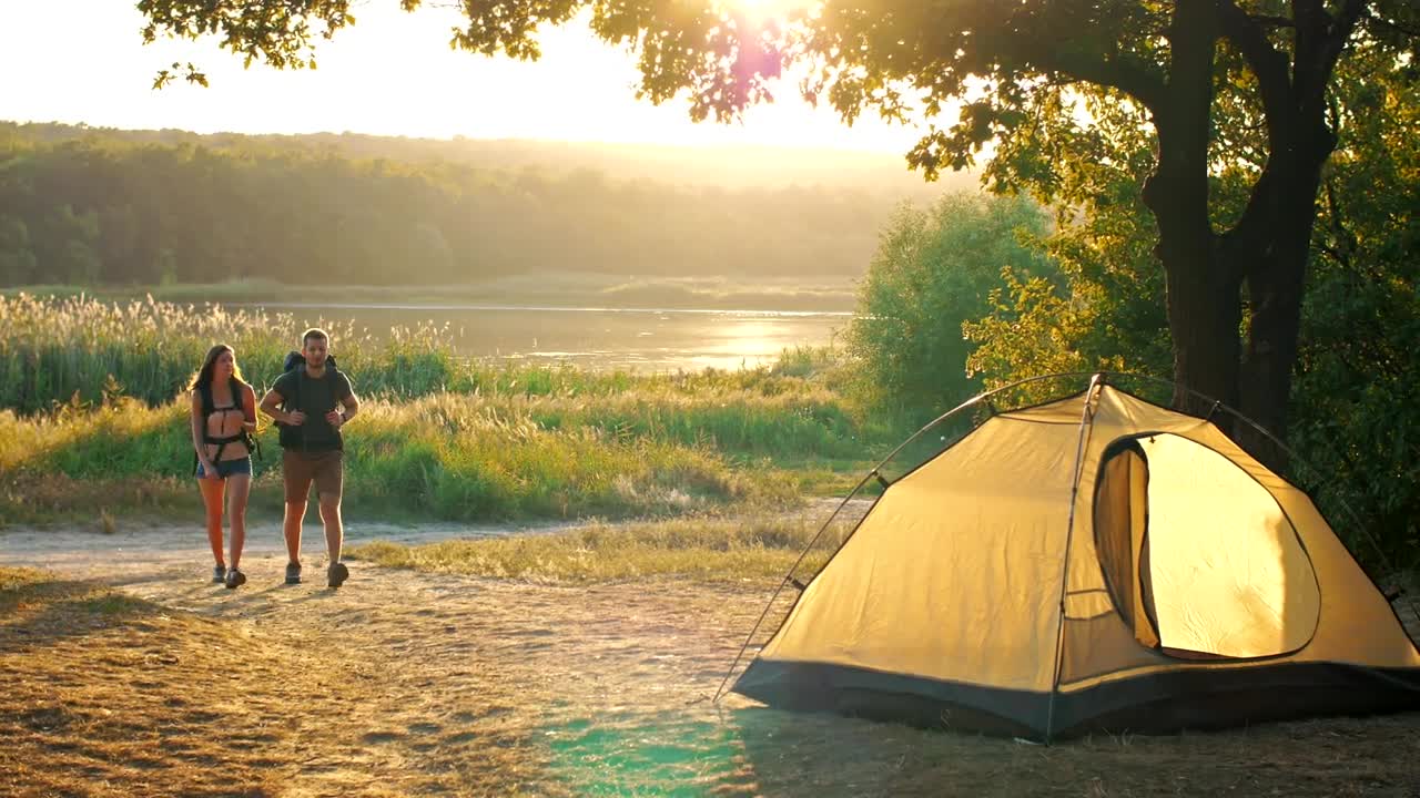 Stock Video Man And Woman Returning To Their Camp In Nature Animated Wallpaper
