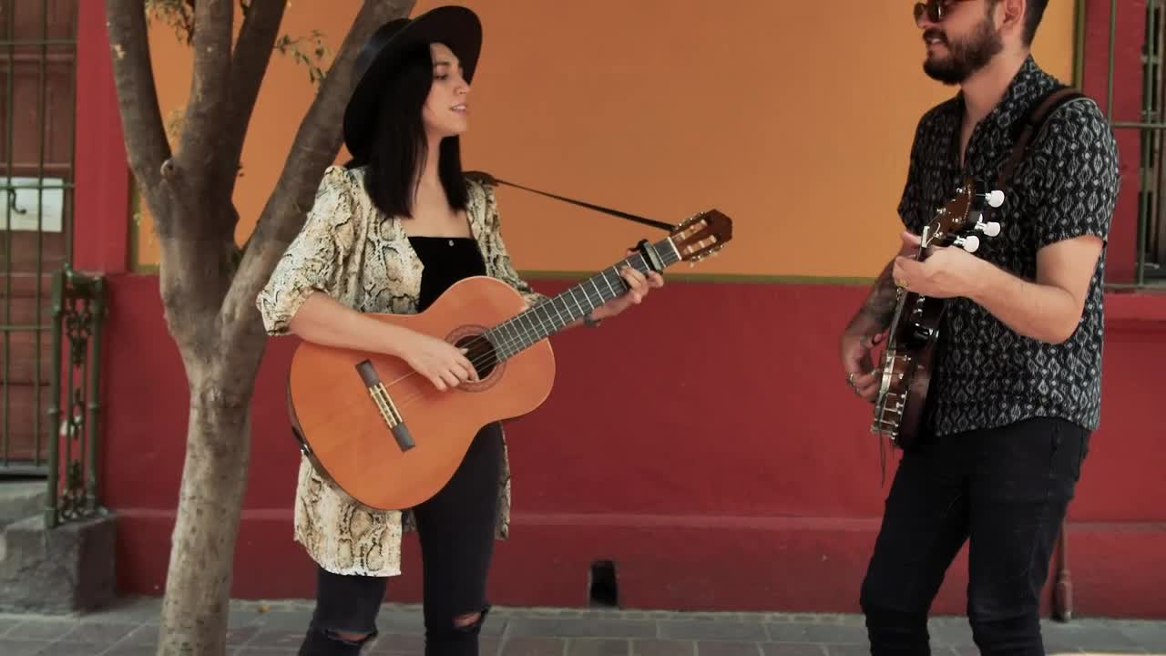 Stock Video Man And Woman Playing Music On The Street Asking For Animated Wallpaper