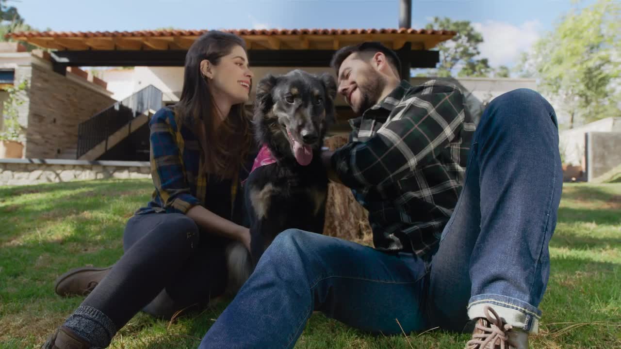 Stock Video Man And Woman Petting Their Dog In A Garden Animated Wallpaper
