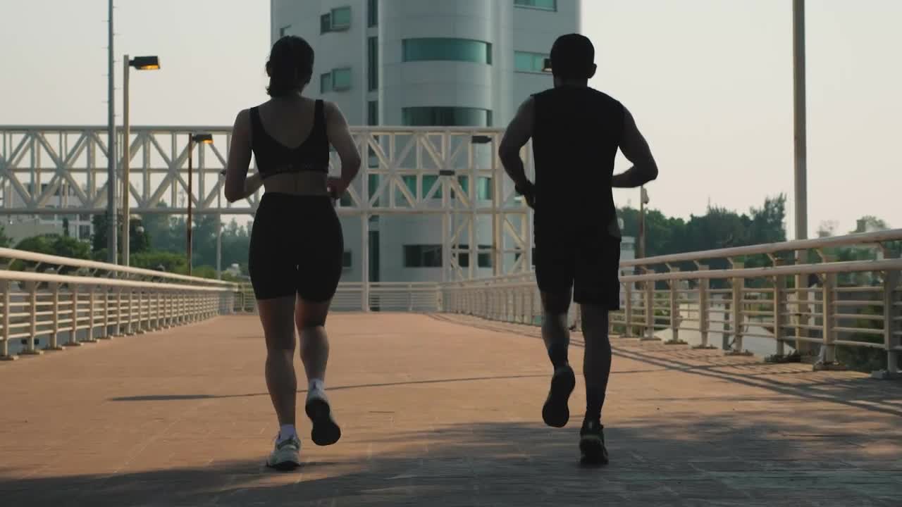 Stock Video Man And Woman Jogging Together On The Street Animated Wallpaper