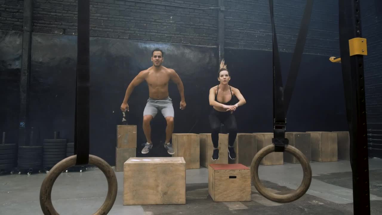 Stock Video Man And Woman Doing Box Jump Animated Wallpaper