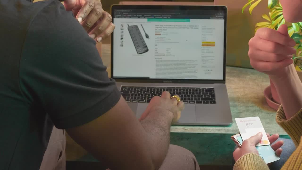 Stock Video Man And Woman Buying Online On A Laptop Animated Wallpaper
