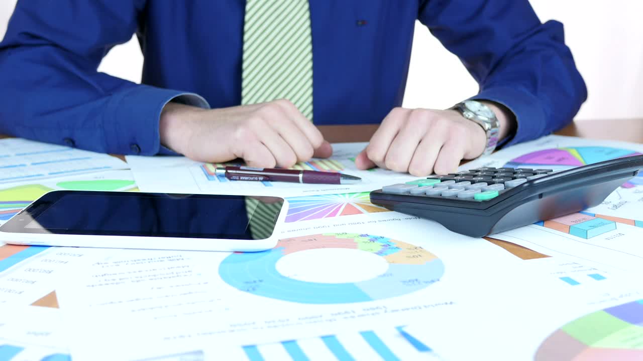 Stock Video Man Analyzing The Charts Animated Wallpaper