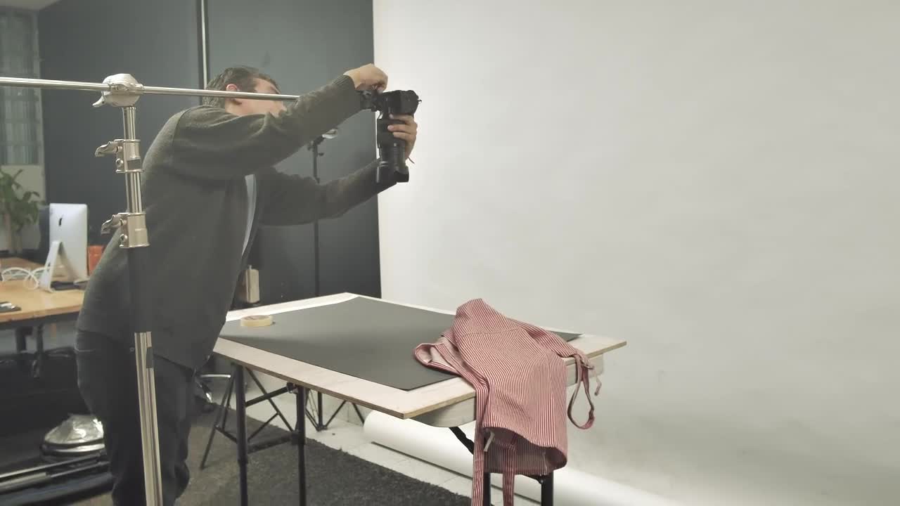 Stock Video Man Adjusting A Camera In The Studio Animated Wallpaper