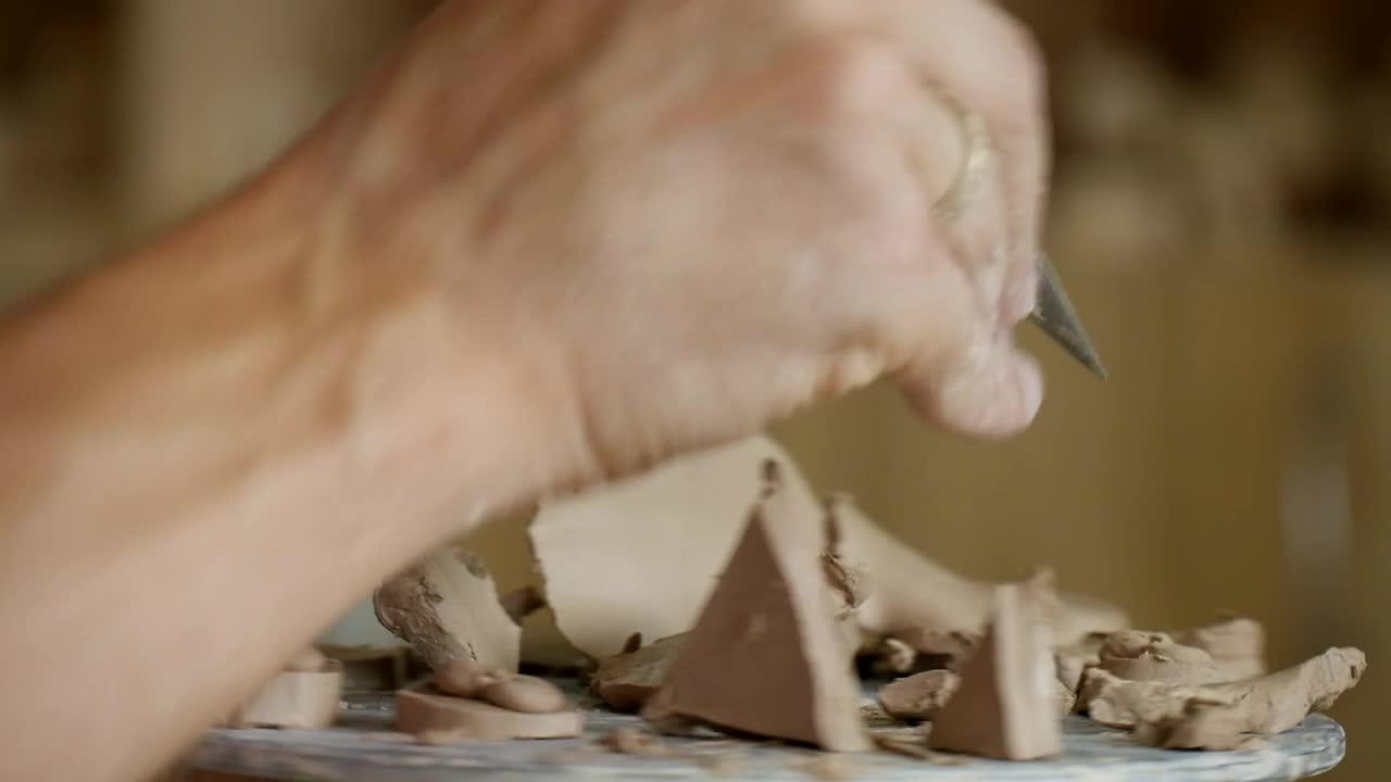 Stock Video Male Working On Clay With Cutting Tools Animated Wallpaper
