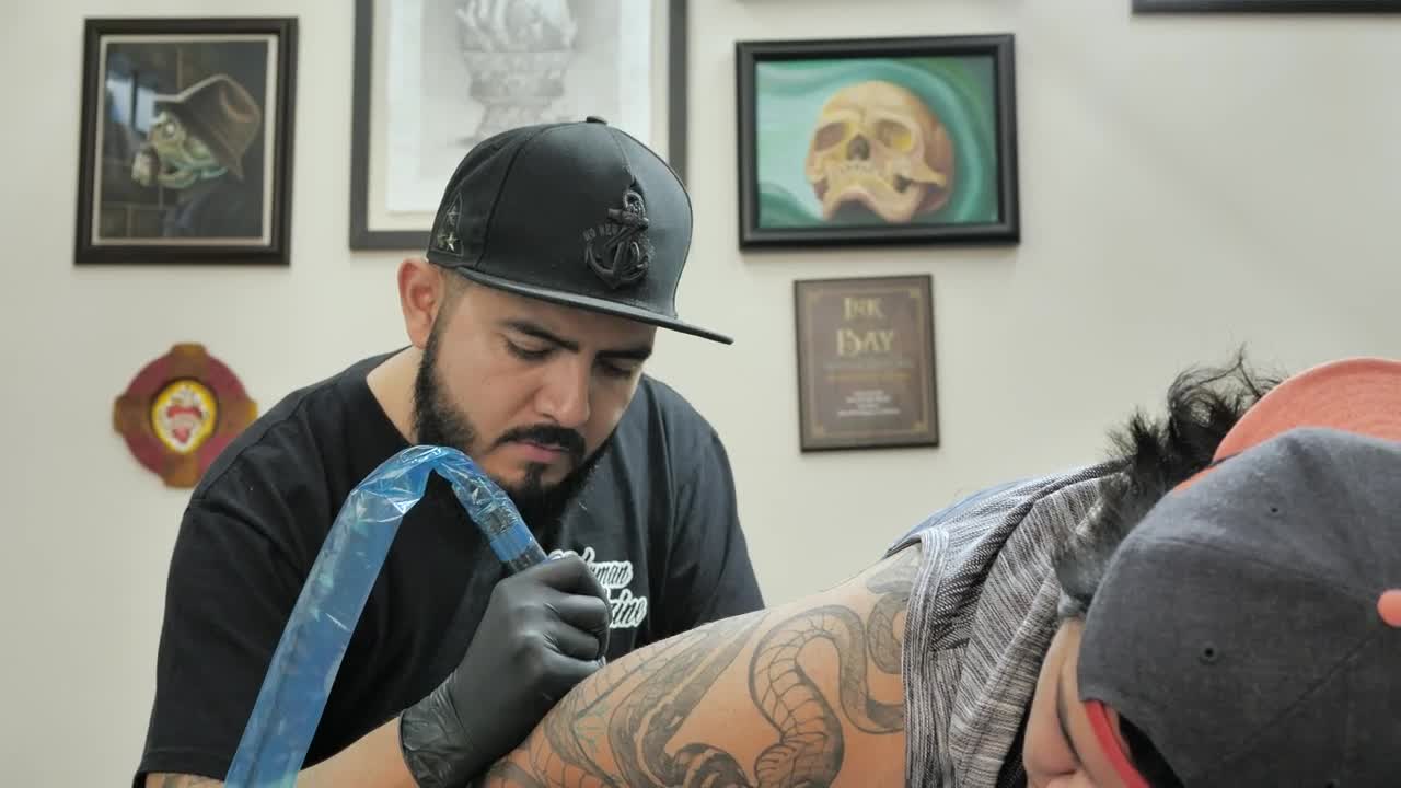Stock Video Male Tattooist Working On A Tattoo Animated Wallpaper
