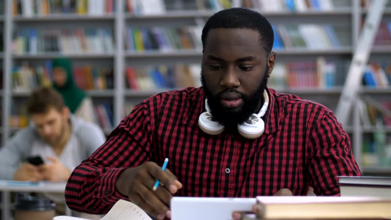 Stock Video Male Student Reading In The Library Animated Wallpaper