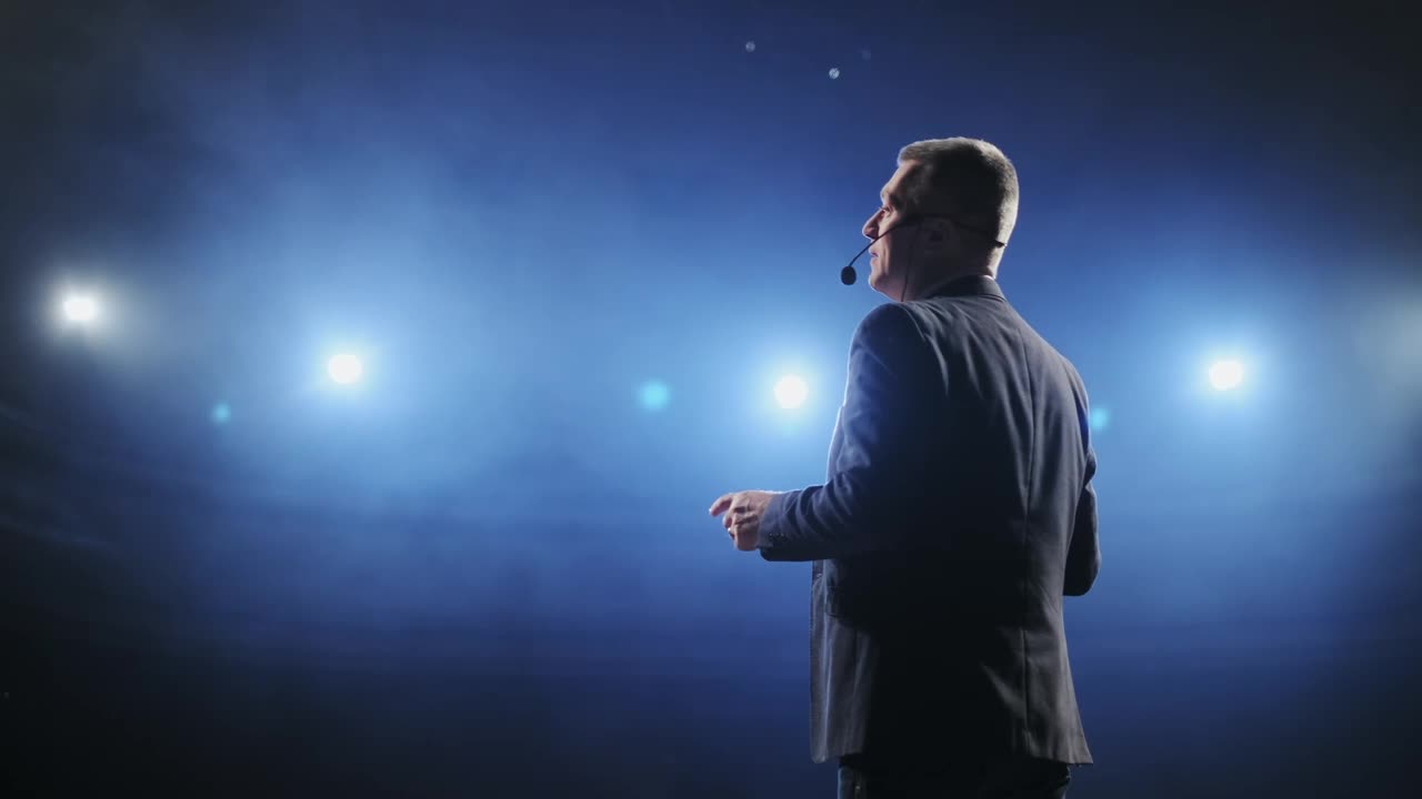 Stock Video Male Speaker Giving A Talk At A Stage Animated Wallpaper