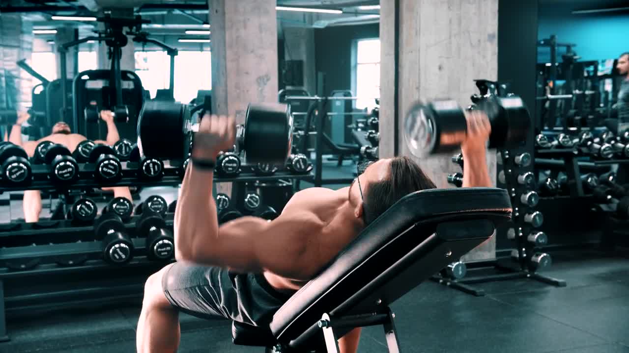 Stock Video Male Bodybuilder Doing Chest Exercises With Dumbbells Animated Wallpaper