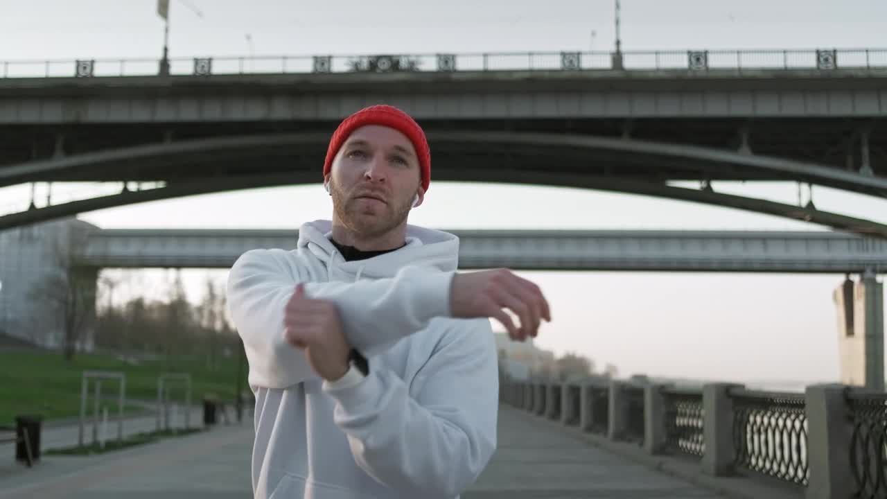 Stock Video Male Athlete Stretching His Arms Before Training Animated Wallpaper