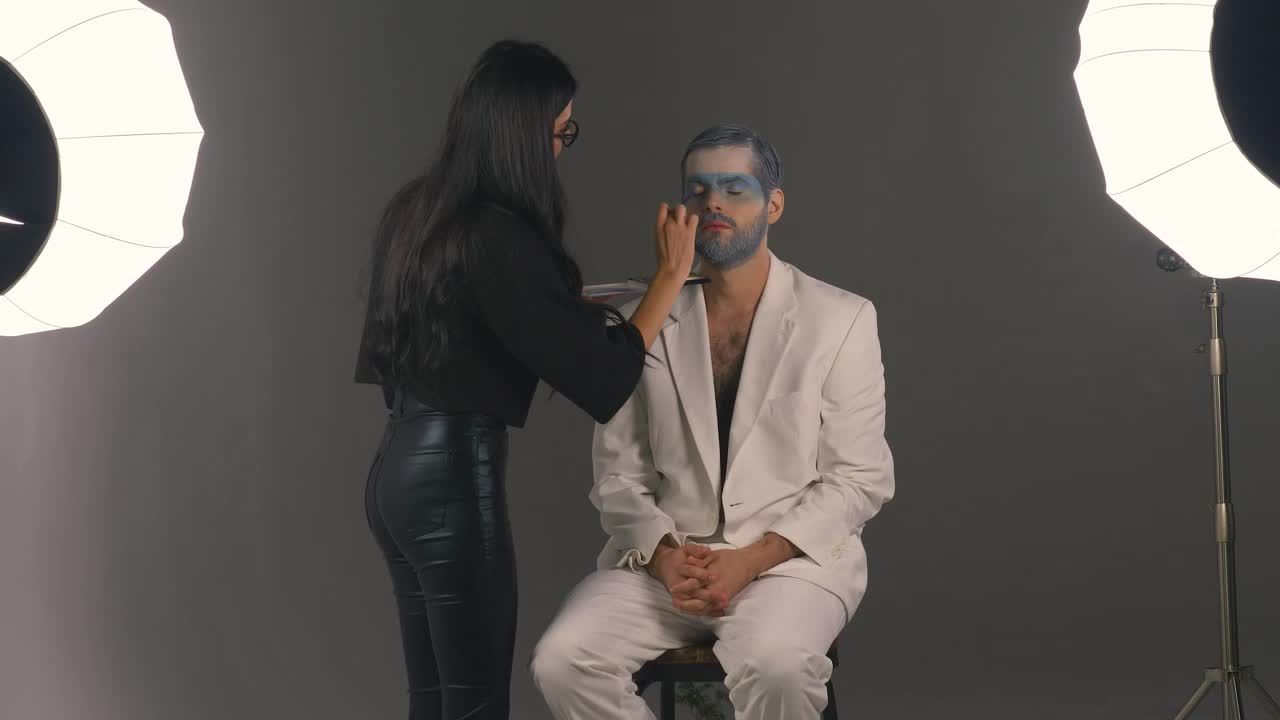 Stock Video Making Up A Man Winter Style In A Photography Set Animated Wallpaper