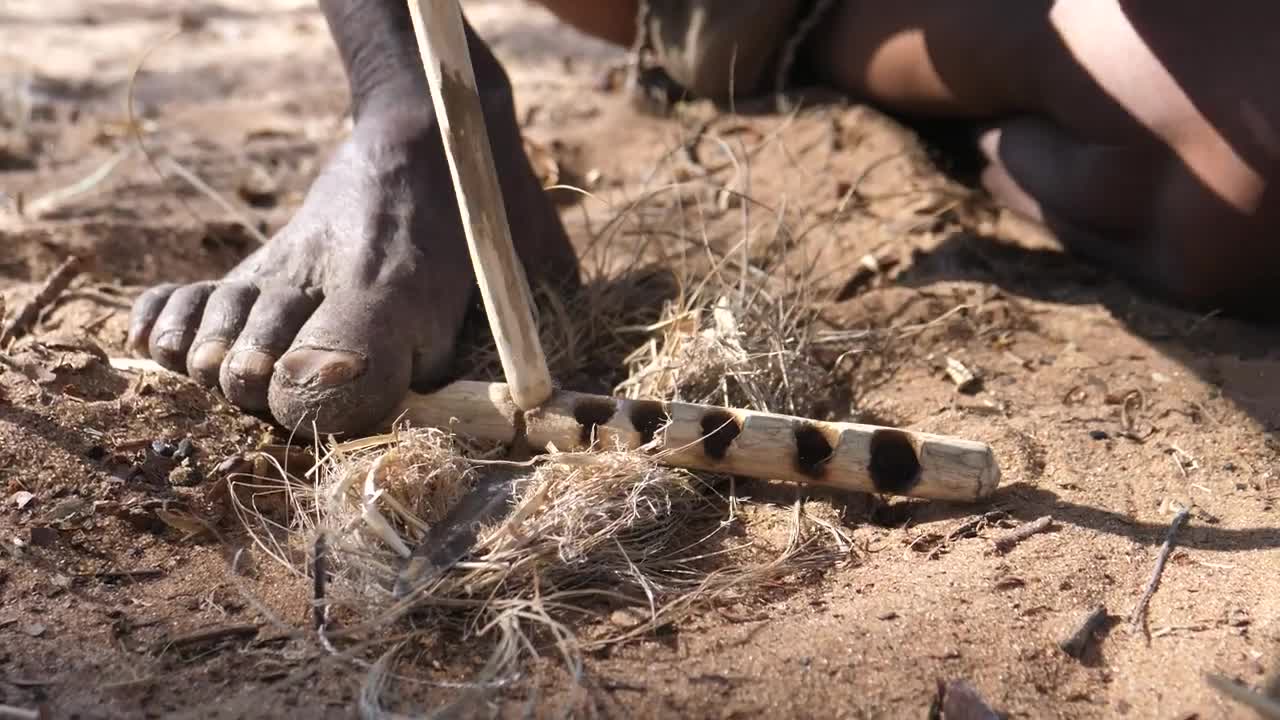 Stock Video Making Fire With Wooden Sticks On The Ground Animated Wallpaper