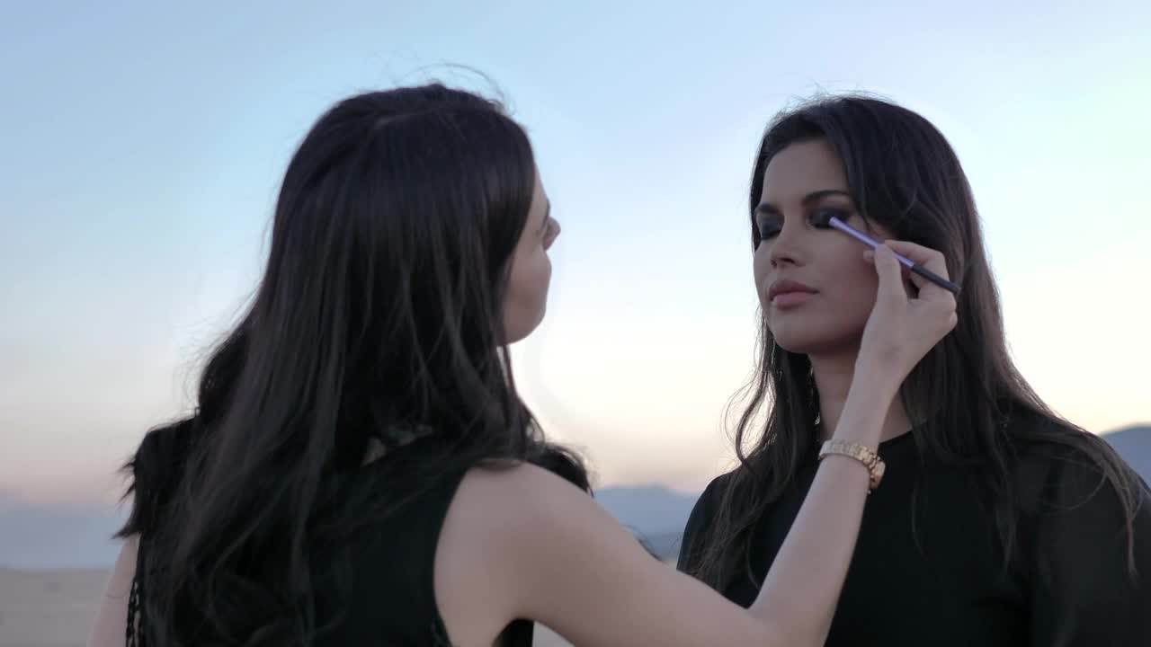 Stock Video Makeup Artist Putting Makeup On A Model Animated Wallpaper