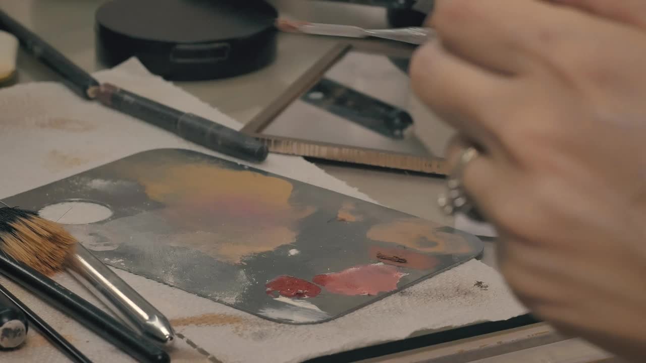 Stock Video Makeup Artist Mixing Makeup On A Palette Animated Wallpaper