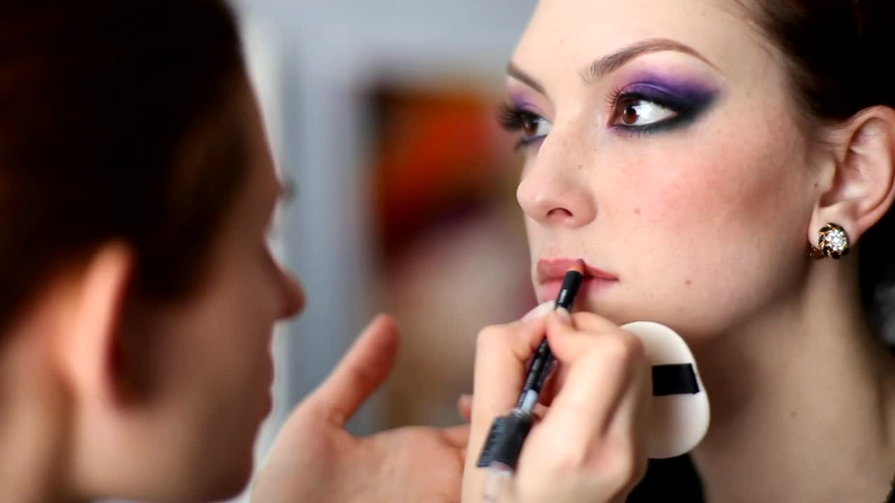 Stock Video Makeup Artist Doing Lips On A Model Animated Wallpaper