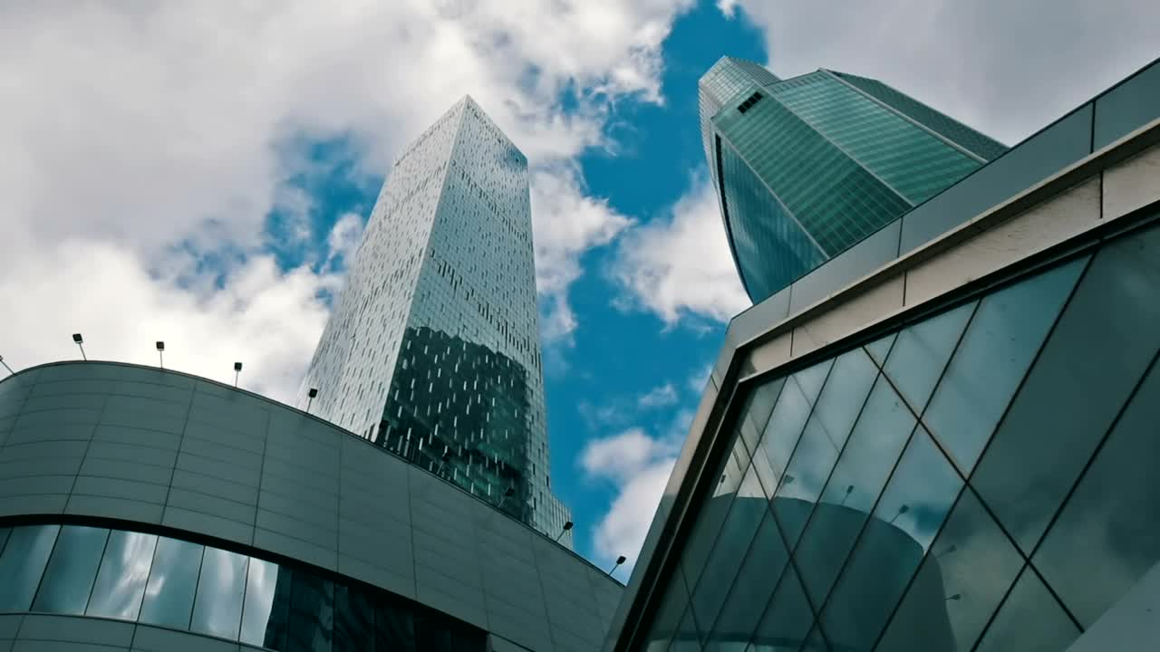 Stock Video Low View Of Office Buildings With Clouds In The Sky Animated Wallpaper