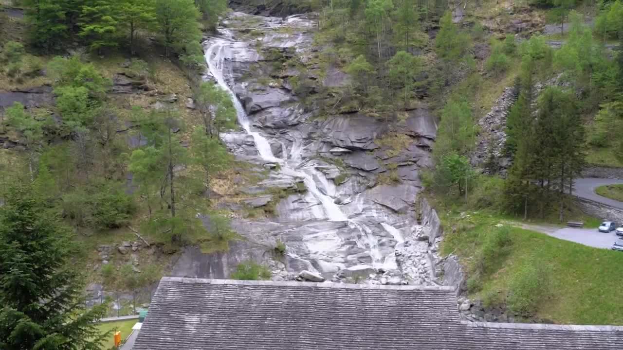 Stock Video Low View Of A Waterfall On A Forested Mountain Animated Wallpaper