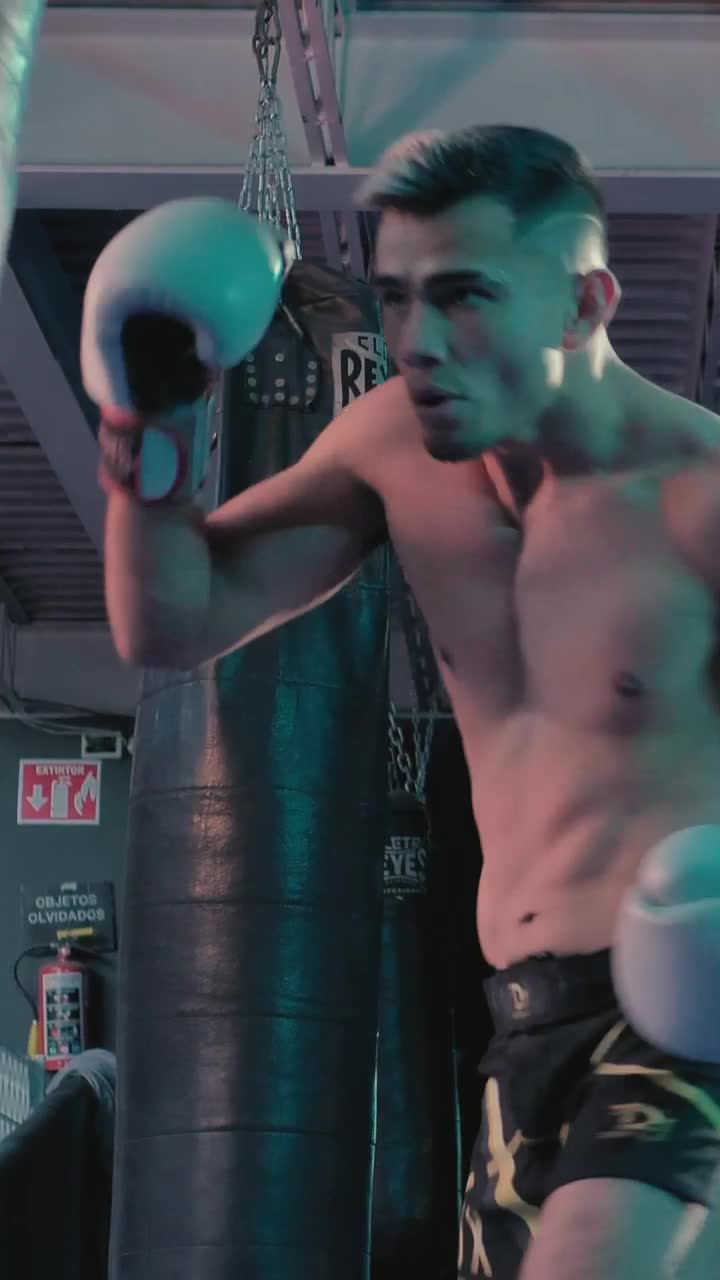Stock Video Low View Of A Boxer Punching A Boxing Bag Animated Wallpaper