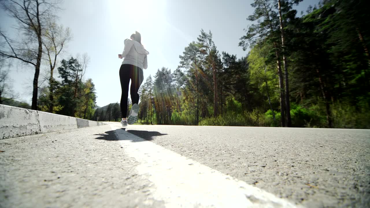 Stock Video Low Angle Of Runner Jogging On Forest Road Animated Wallpaper