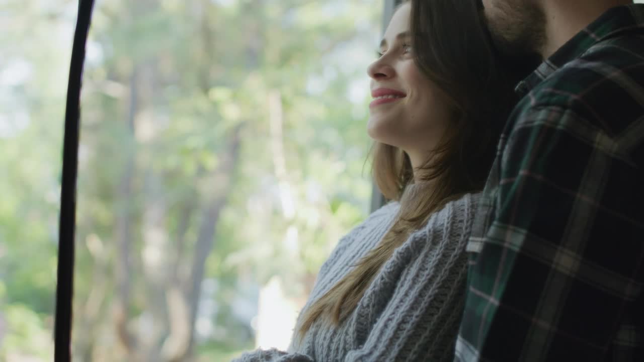 Stock Video Loving Couple Embracing In Front Of The Window Animated Wallpaper