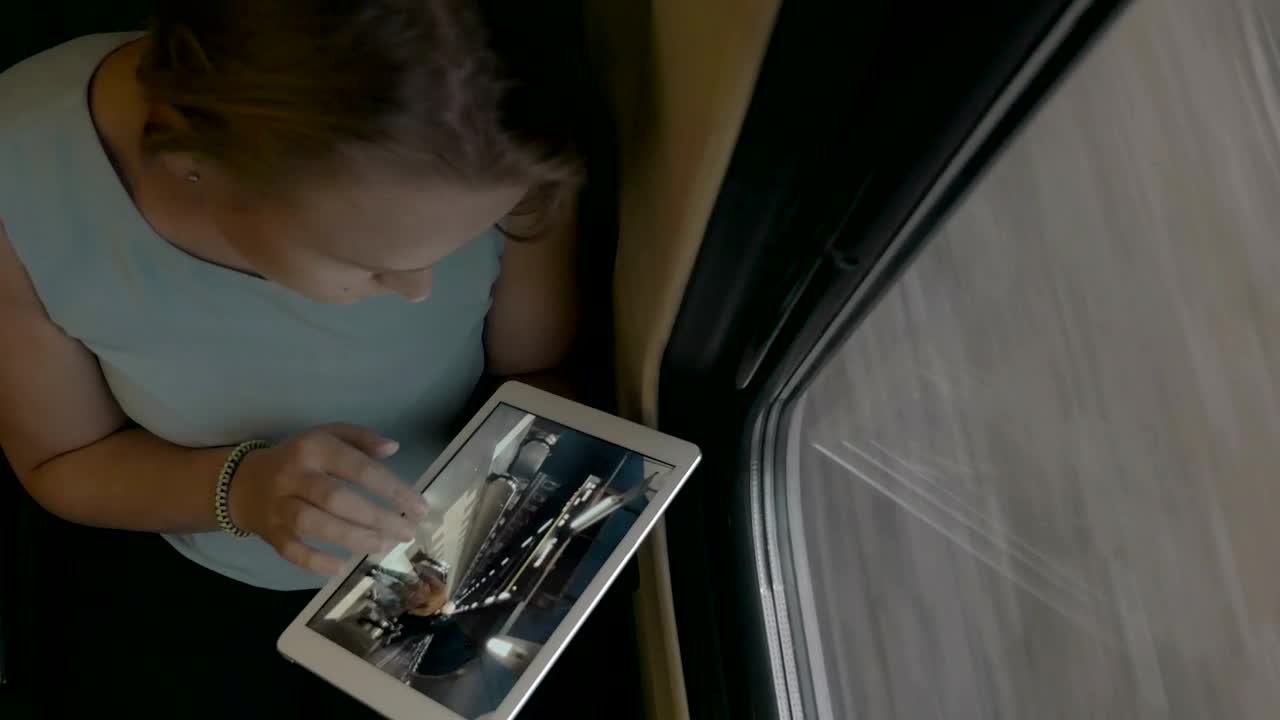 Stock Video Looking At Photos On A White Tablet Animated Wallpaper