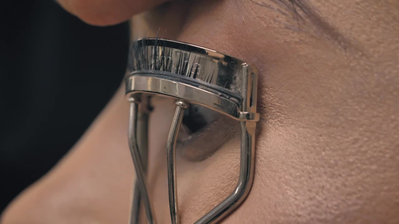 Stock Video Look Of A Woman With An Eyelash Curler Animated Wallpaper