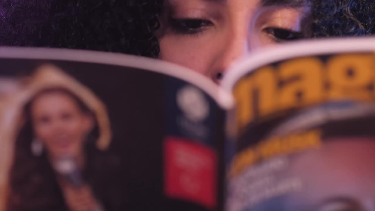 Stock Video Look Of A Girl While She Reads A Magazine Animated Wallpaper