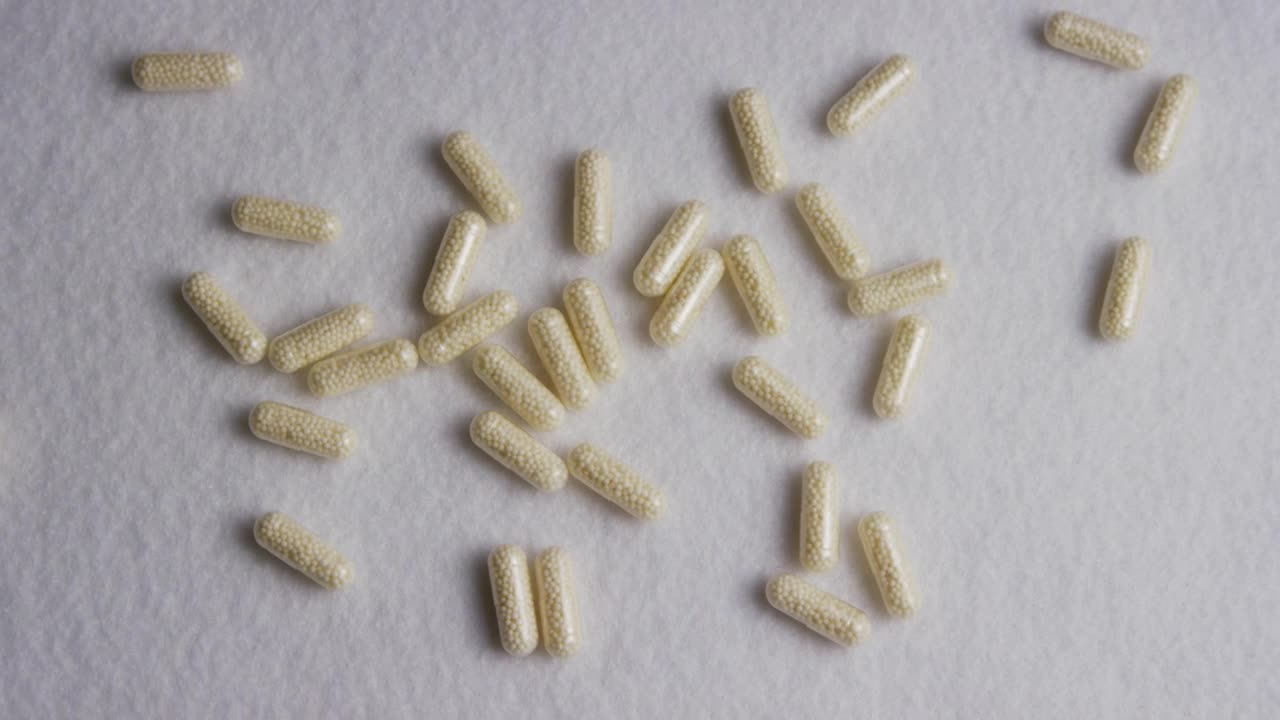 Stock Video Little White Pills On A White Texture Animated Wallpaper