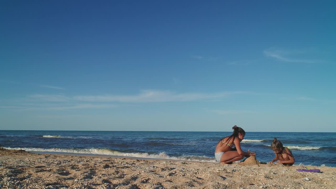 Stock Video Little Sisters Making Castles In The Sand Animated Wallpaper