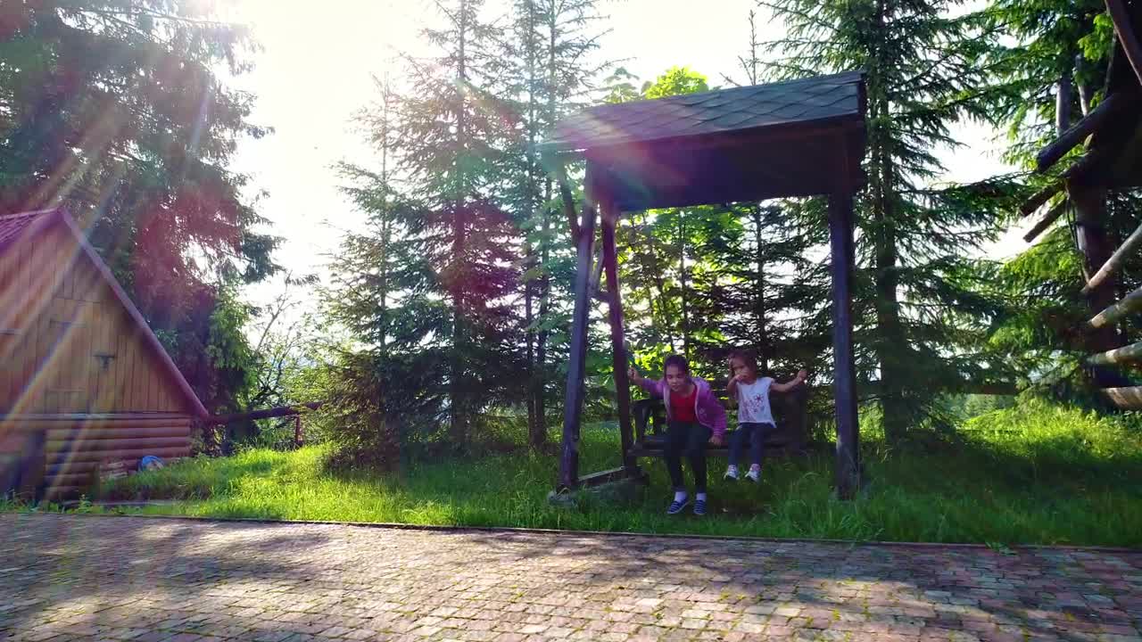 Stock Video Little Girls On A Swing In The Country House Animated Wallpaper