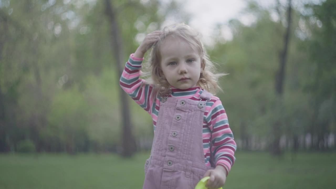 Stock Video Little Girl With Oversized Crown Plays In Park Animated Wallpaper