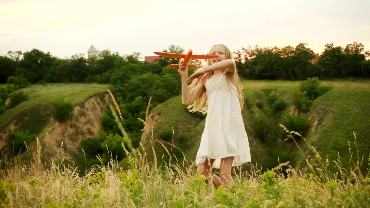 Stock Video Little Girl Throwing A Toy Plane In The Hills Animated Wallpaper