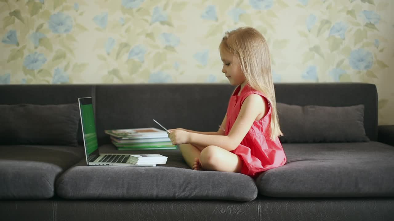 Stock Video Little Girl Taking Her Classes On The Couch Animated Wallpaper