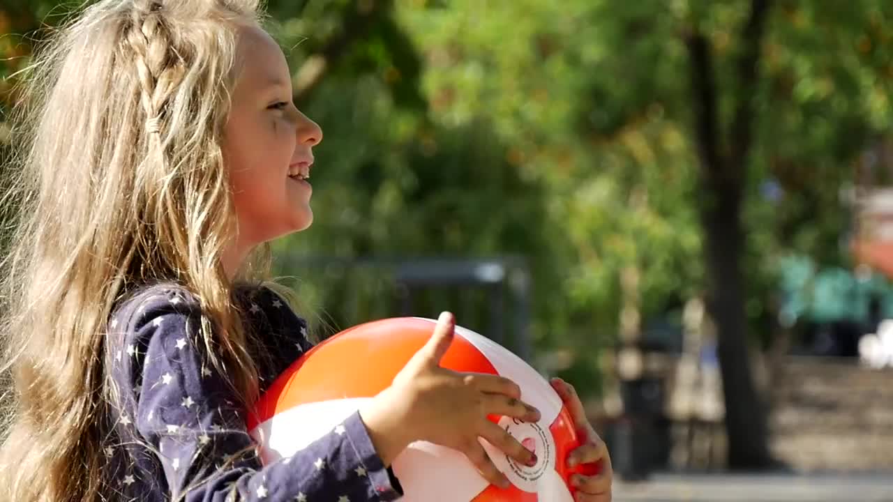 Stock Video Little Girl Smiling Holding Plastic Ball Animated Wallpaper