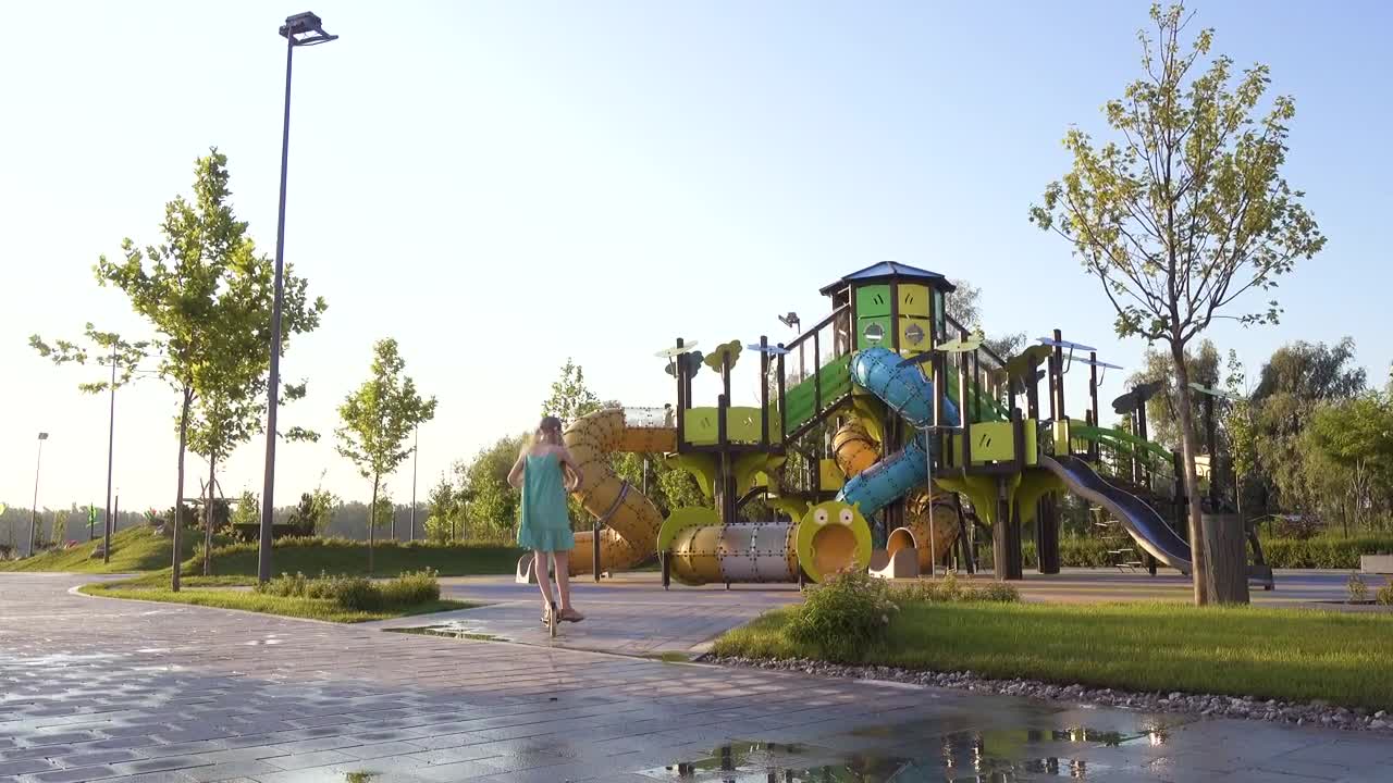 Stock Video Little Girl Riding A Scooter In The Park Animated Wallpaper