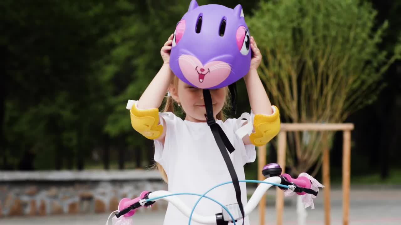 Stock Video Little Girl Puts On A Protective Bicycle Helmet Animated Wallpaper
