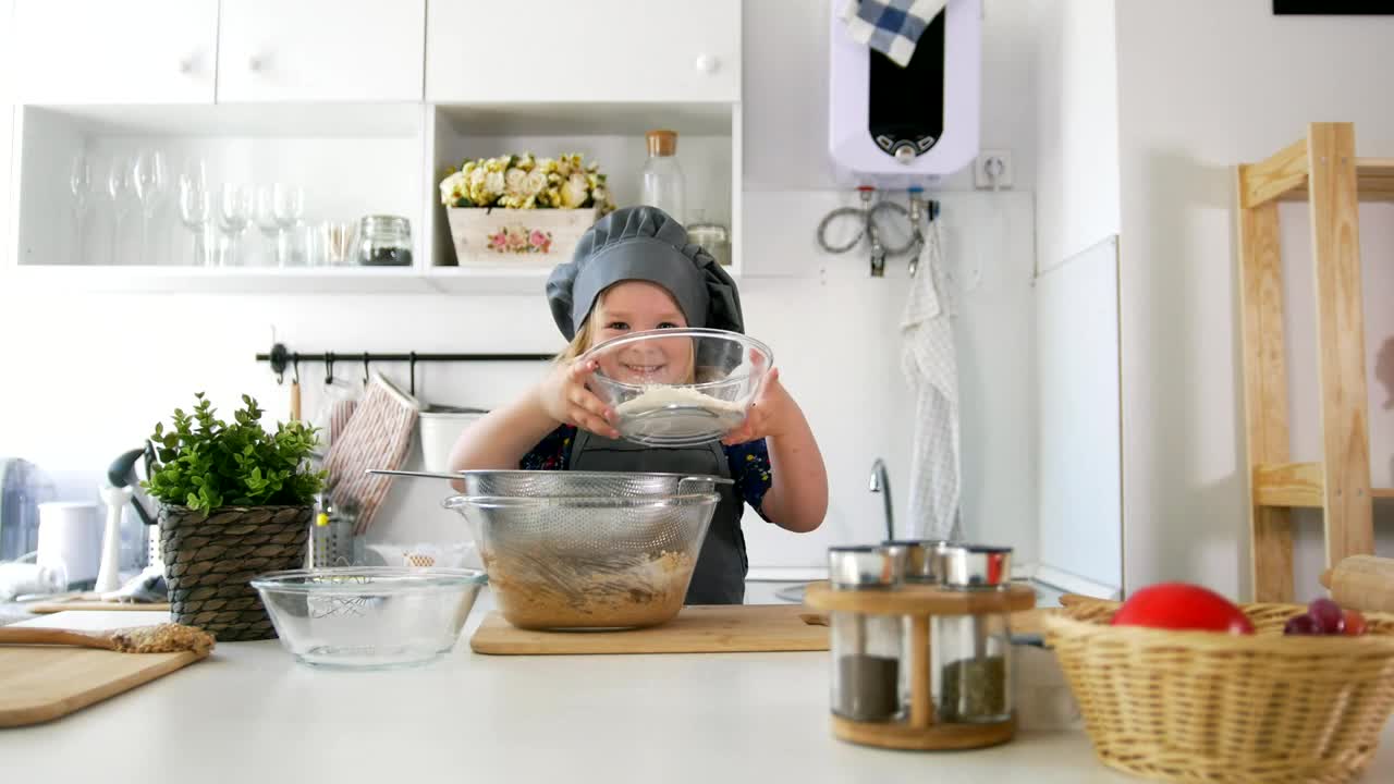 Stock Video Little Girl Preparing A Cookie Mix Animated Wallpaper