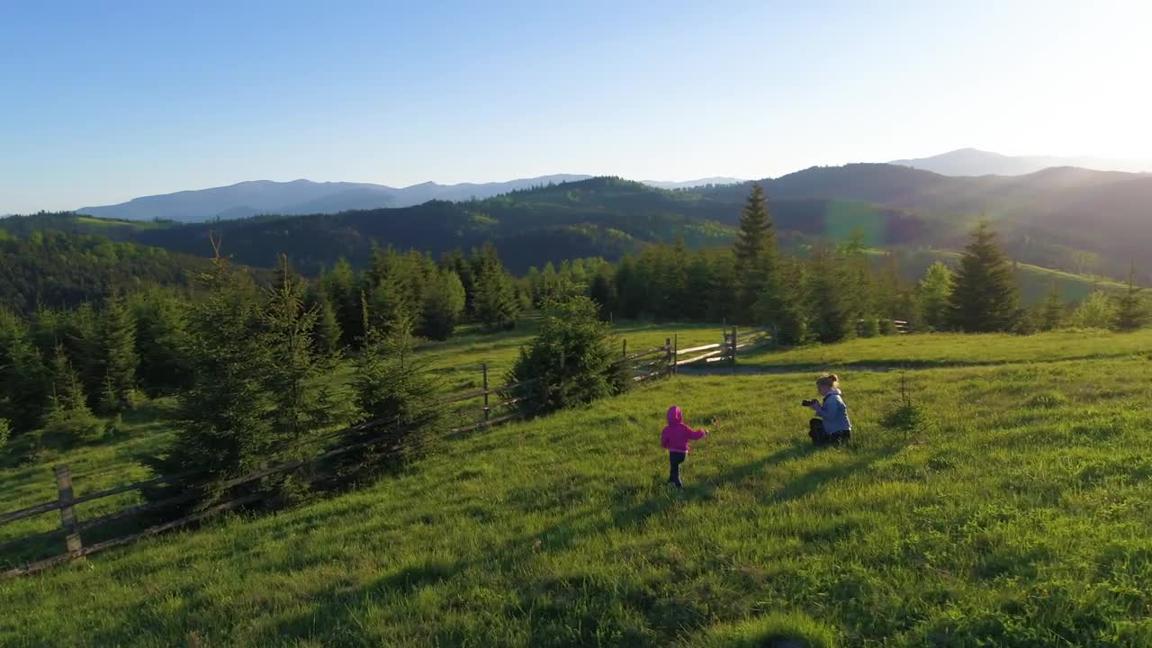 Stock Video Little Girl Plays With Her Mother In The Meadow Animated Wallpaper