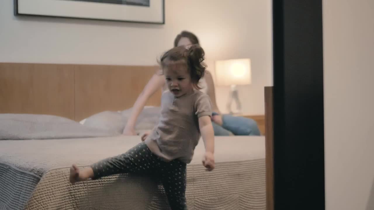 Stock Video Little Girl Plays At Home Near Her Mother Animated Wallpaper